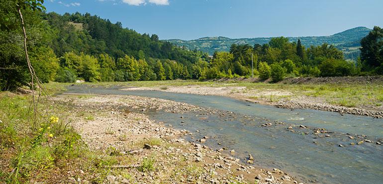 Low flowing river bed. Reduction of river waters in summer. (daphnusia images via Shutterstock)