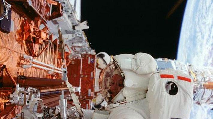 Astronaut Kathryn C. Thorton works with equipment to service the Hubble Space Telescope during the STS-61 mission (NASA).