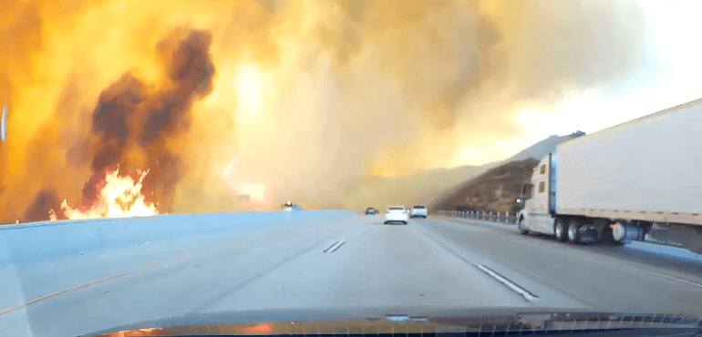 Drivers were forced to pass through flames and smoke on a freeway in Los Angeles.