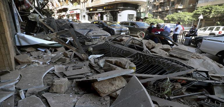 Men on a scooter pass cars and buildings that were damaged after a massive explosion on Tuesday, in Beirut, Lebanon, Wednesday, Aug. 5, 2020. The explosion flattened much of a port and damaged buildings across Beirut, sending a giant mushroom cloud into the sky. In addition to those who died, more than 3,000 other people were injured, with bodies buried in the rubble, officials said. (AP Photos/Bilal Hussein)