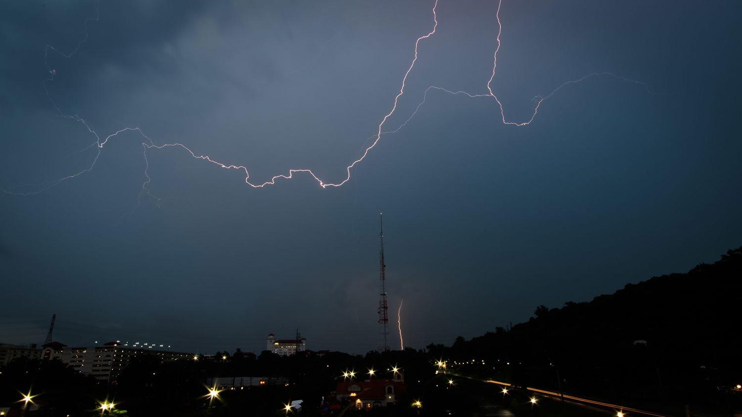 Lightning streaks across the sky while a bolt simultaneously strikes the ground near Montclair State University in Little Falls, New Jersey on July 17, 2021. (Robert Hectus)