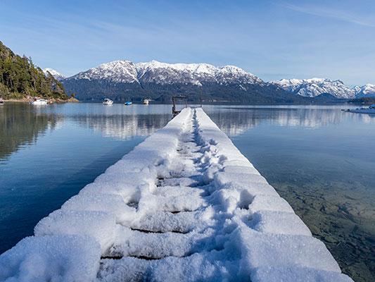 Snow covers a dock in Villa La Angostura in southern Argentina, Monday, July 17, 2017. The National Meteorological Service says that the cold front comes all the way from the South Pole. (AP Photo/Federico Grosso)
