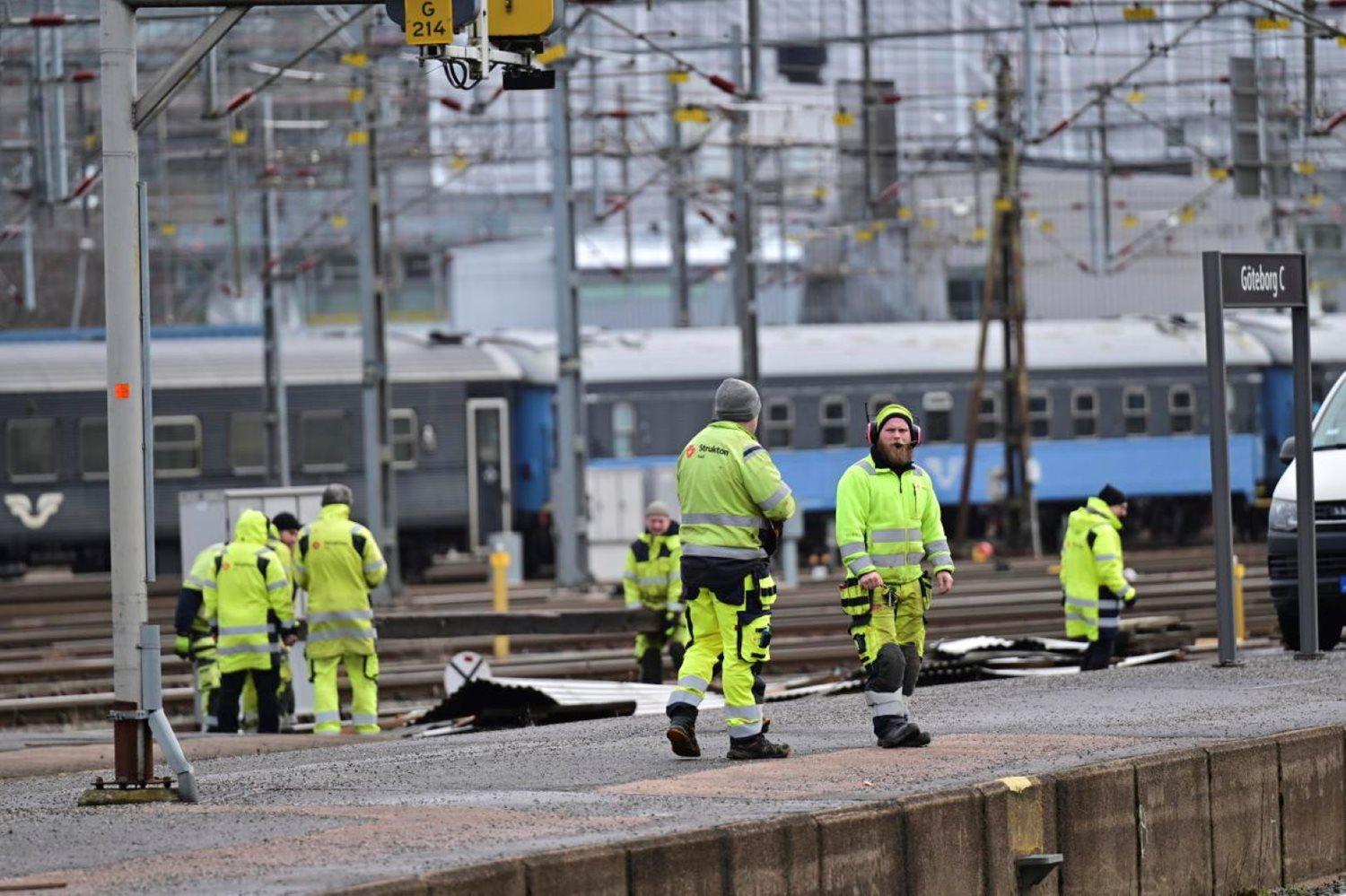 Workers remove a piece of roof that was blown off by strong winds at the main train station in Goteborg, Sweden, Friday, Feb. 23, 2024, causing no injuries but knocking out power and stopping all rail traffic in and out of Sweden’s second largest city. (Björn Larsson Rosvall/TT News Agency via AP)
