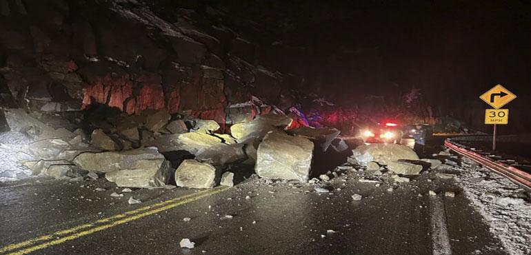 In this photo provided by the California Highway Patrol, fallen boulders from Echo Summit block U.S. Highway 50 in El Dorado County, Calif., early Wednesday, Dec. 20, 2023. The roadway was closed for three hours following the rockslide. (California Highway