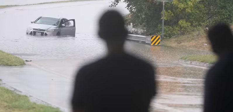 A swamped car sits in flood waters covering a closed highway in Dallas, Monday, Aug. 22, 2022. (AP Photo/LM Otero)