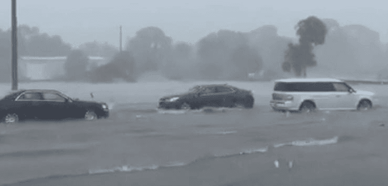 Cars drive through a flooded parking lot in Vero Beach, Fla. (Courtesy Mike Wagner)