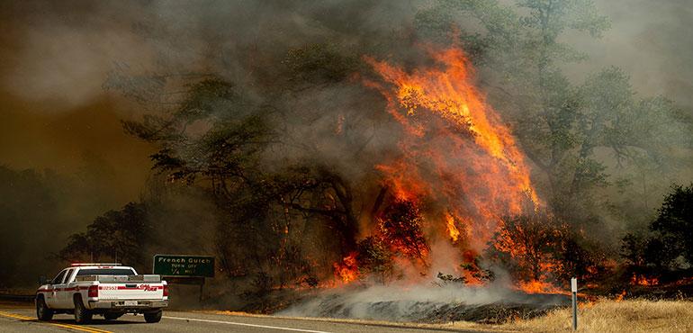 Homes leveled by the Carr Fire line the Lake Keswick Estates area of Redding, Calif., on Friday, July 27, 2018. (AP Photo/Noah Berger)
