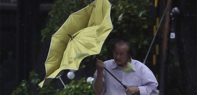 A man struggles with his umbrella against gusts of wind generated by Typhoon Kong-rey in Taipei, Taiwan, Thursday, Oct. 31, 2024. (AP Photo/Chiang Ying-ying)
