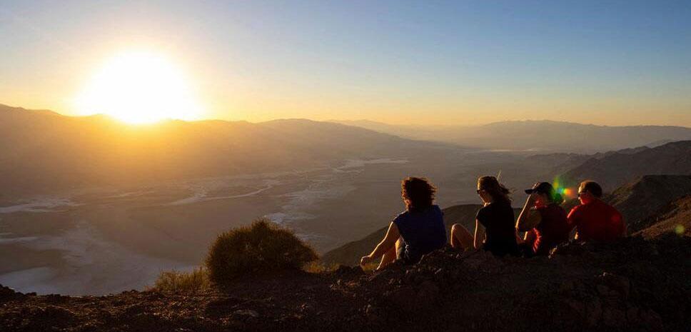 Park visitors watch the sunset on Tuesday, July 11, 2023, in Death Valley National Park, Calif. (AP Photo/Ty ONeil)