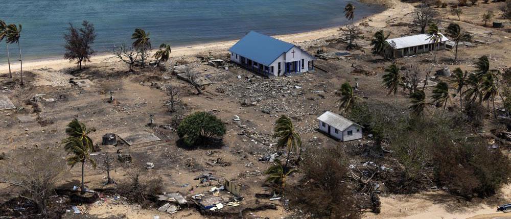 In this photo provided by the Australian Defence Force, debris from damaged building and trees are strewn around on Atata Island in Tonga, on Jan. 28, 2022, following the eruption of an underwater volcano and subsequent tsunami. (POIS Christopher Szumlanski/Australian Defence Force via AP, File)