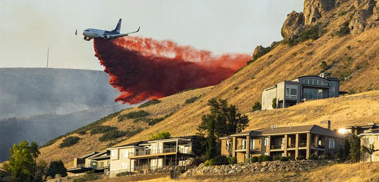 A plane drops fire retardant as the Sandhurst Fire burns above Ensign Peak north of Salt Lake City on Saturday, July 20, 2024. (Isaac Hale/The Deseret News via AP)