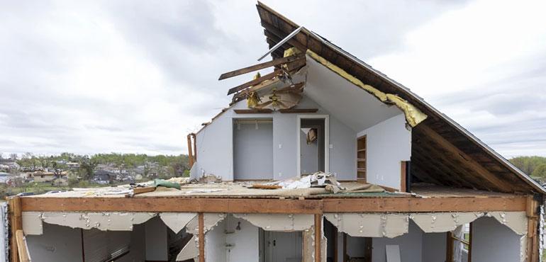 A partially torn off roof is seen on a damaged home in Omaha, Neb., on Saturday, April 27, 2024. Dozens of reported tornadoes wreaked havoc Friday in the Midwest. (Chris Machian/Omaha World-Herald via AP)