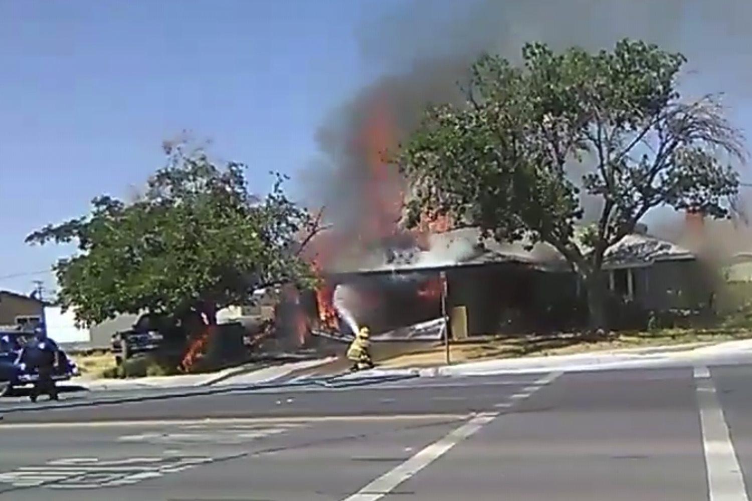In this image taken from video provided by Ben Hood, a firefighter works to extinguish a fire, Thursday, July 4, 2019, following an earthquake in Ridgecrest, Calif. (Ben Hood via AP)