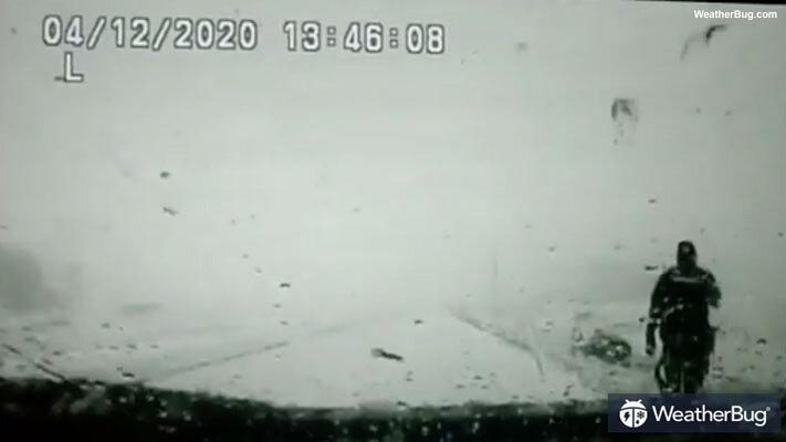 Police dashcam footage shows a car striking the open door of a police vehicle and debris hurtling toward an officer. (Marathon County Sheriff's Office via Storyful)