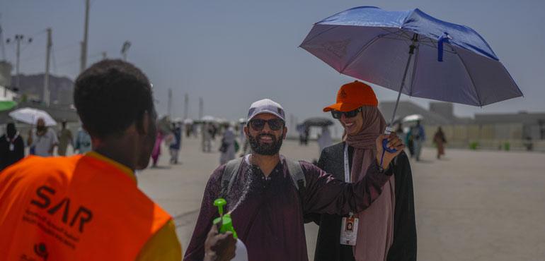 A pilgrim receives cold water spray after he cast stones at a pillar in the symbolic stoning of the devil, the last rite of the annual Hajj pilgrimage in Mina, near the holy city of Mecca, Saudi Arabia.