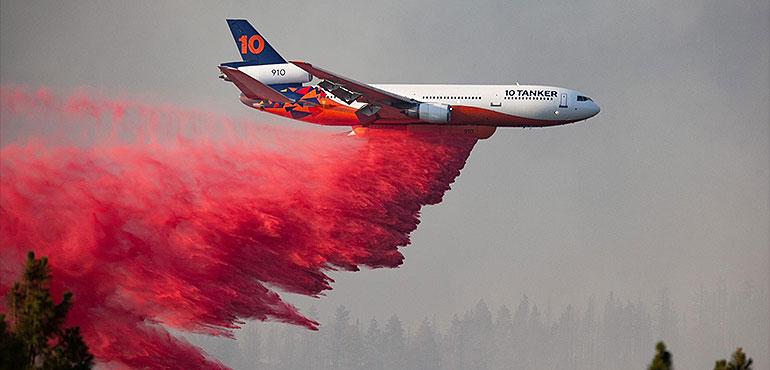 In this photo provided by the Bootleg Fire Incident Command, a DC-10 tanker drops retardant over the Bootleg Fire in southern Oregon, Thursday, July 15, 2021. (Bootleg Fire Incident Command via AP)