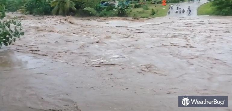 Floodwaters submerge Fiji roadway.