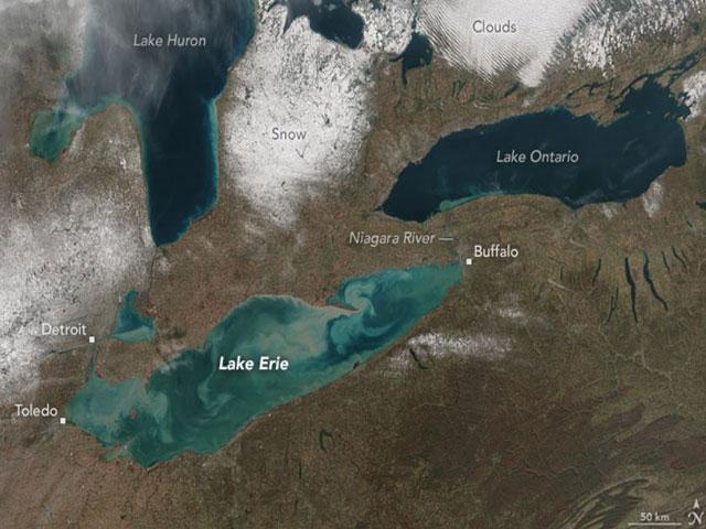 High sediment water is seen entering Lake Ontario from Lake Erie via the Niagara River following a seiche in late November 2015. A strong southwest wind ahead of a cold front carried sediment from western Lake Erie to the northeast corner of the lake. (Courtesy of Jesse Allen, NASA Earth Observatory and Suomi National Polar-orbiting Partnership).