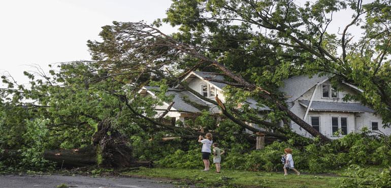 Max Comer and his sons, Finnegan, 9, and McCoy, 5, view storm damage to their next door neighbor's home, Sunday, May 26, 2024, in Claremore, Okla. Powerful storms left a wide trail of destruction Sunday across Texas, Oklahoma and Arkansas after obliterating Max Comer and his sons, Finnegan, 9, and McCoy, 5, view storm damage to their next door neighbor's home, Sunday, May 26, 2024, in Claremore, Okla. Powerful storms left a wide trail of destruction Sunday across Texas, Oklahoma and Arkansas after obliterating homes and destroying a truck stop where dozens sought shelter in a restroom during the latest deadly weather to strike the central U.S. By Mike Simons, AP.