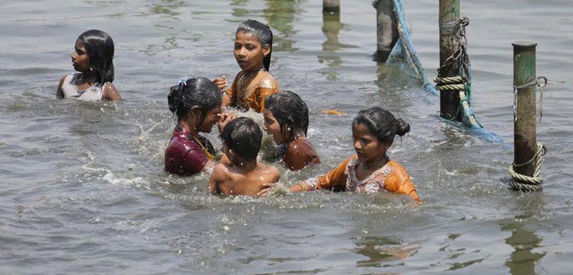 Children cool themselves in the river Gomati as northern Indian continues to reel under intense heat wave in Lucknow in the the Indian state of Uttar Pradesh, April 19, 2023. (AP Photo/Rajesh Kumar Singh, File)