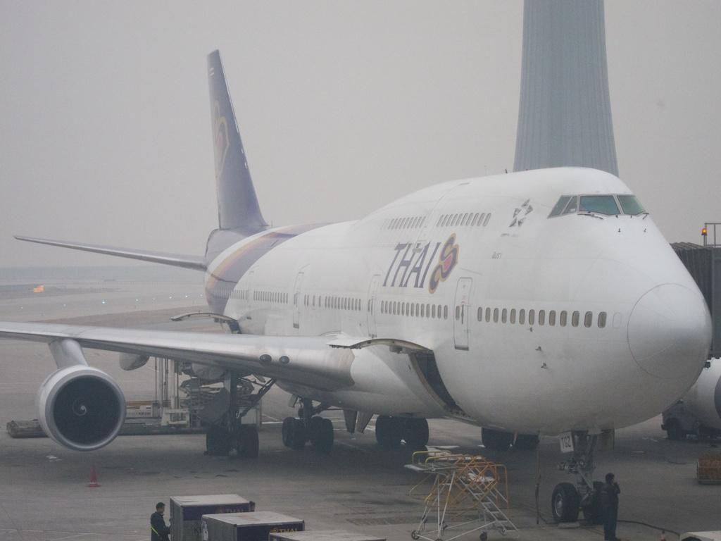 This smog shrouded plane gets ready at Beijing's airport.