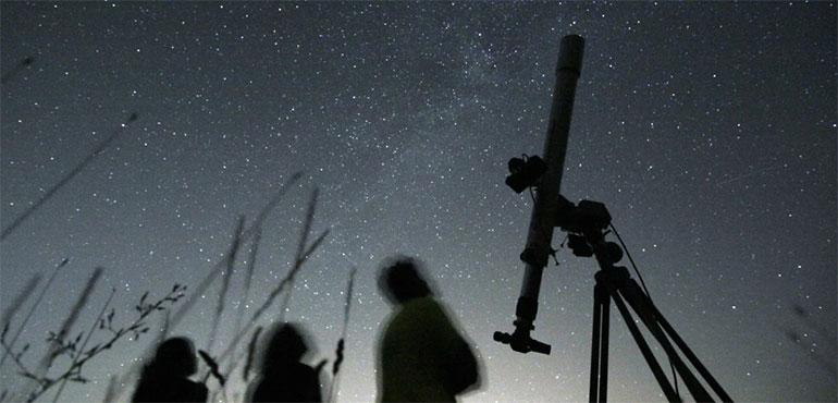 People look up to the sky from an observatory near the village of Avren, Bulgaria, Aug. 12, 2009. (AP Photo/Petar Petrov, File)