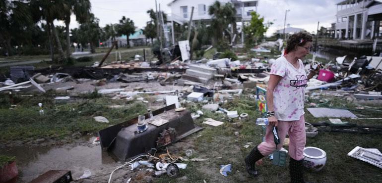 Jewell Baggett walks amidst debris strewn across the yard where her mother's home had stood, in Horseshoe Beach, Fla., after the passage of Hurricane Idalia, Aug. 30, 2023. (Rebecca Blackwell, AP)