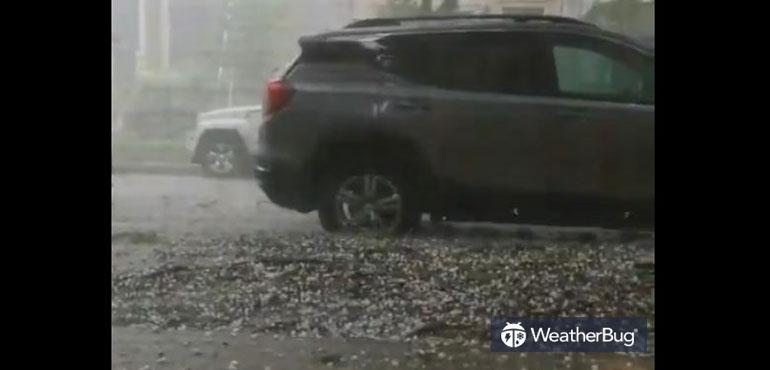 Hail pelts a car in Chicago Illinois.