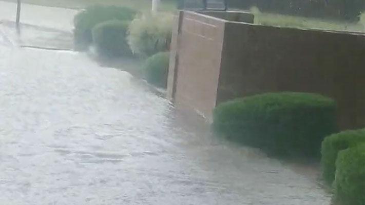 Flooded streets in Santa Fe, N.M., as rain pours down on August 10, 2022.