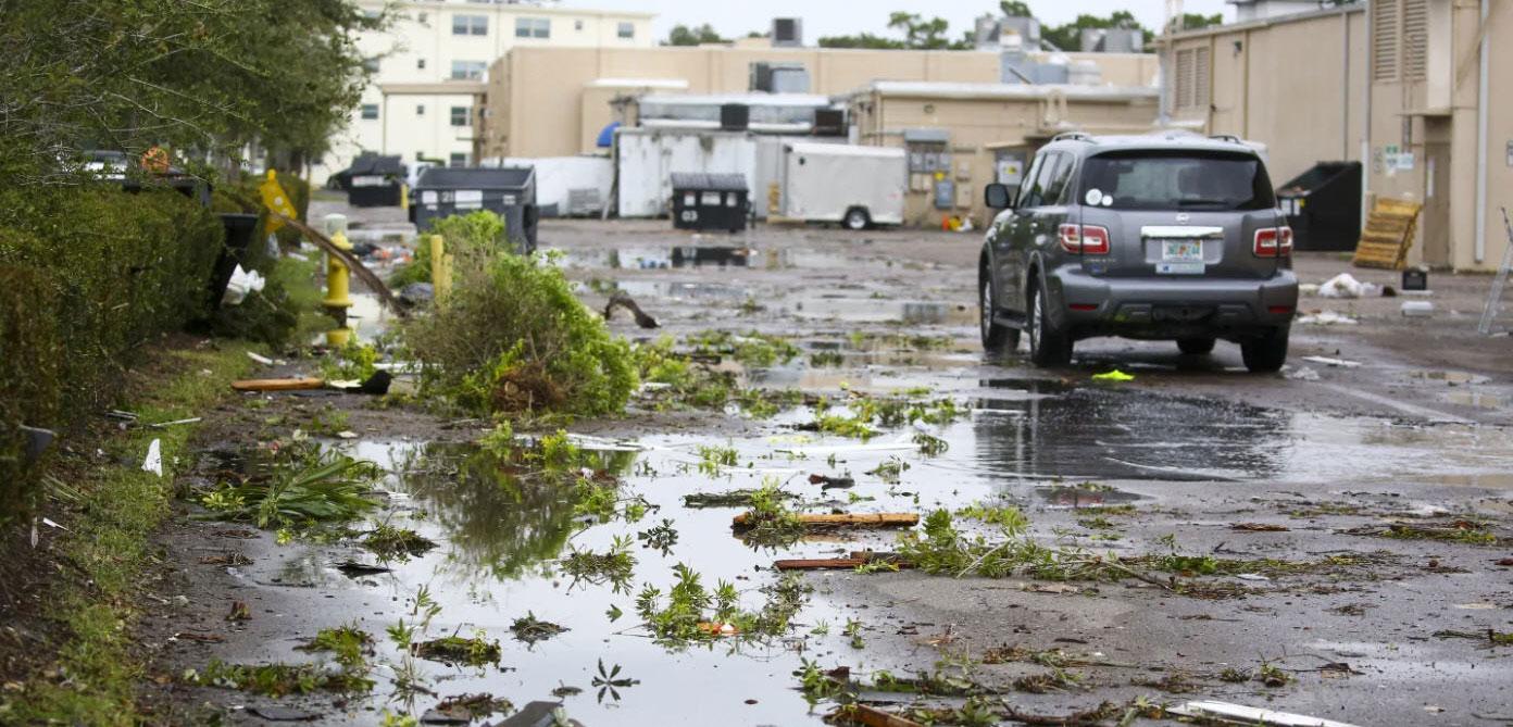 Debris remains strewn across a parking lot at Causeway Plaza in Dunedin, Fla., on Thursday, Oct. 12, 2023. (Douglas R. Clifford/Tampa Bay Times via AP)