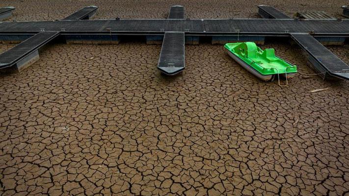 A dock without water is photographed in the Sau reservoir, about 100 km (62 miles) north of Barcelona, Spain, Tuesday, April 18, 2023. Authorities in Spain's parched northeast warned Tuesday that Barcelona and a wide surrounding area home to some 6 million people could face even tighter restrictions of water use in the coming months. (AP Photo/Emilio Morenatti)