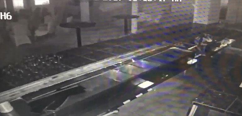 A screen capture of huge waves crashing through a restaurant window.