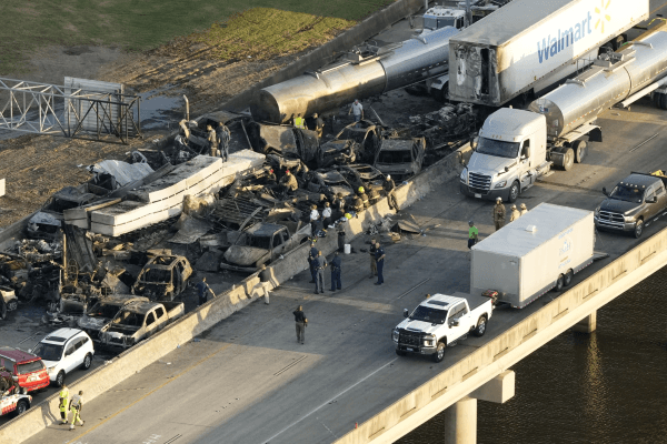 Responders are seen near the wreckage in the aftermath of a multi-vehicle pileup on I-55 near Manchac, LA, Monday, October 23, 2023.