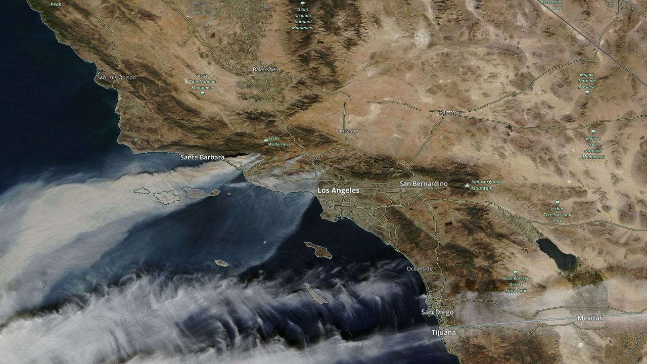 Story Image: Smoke from wildfires in Southern California being blown across the Pacific during a Santa Ana wind event on December 5, 2017. Source NASA Terra/MODIS.