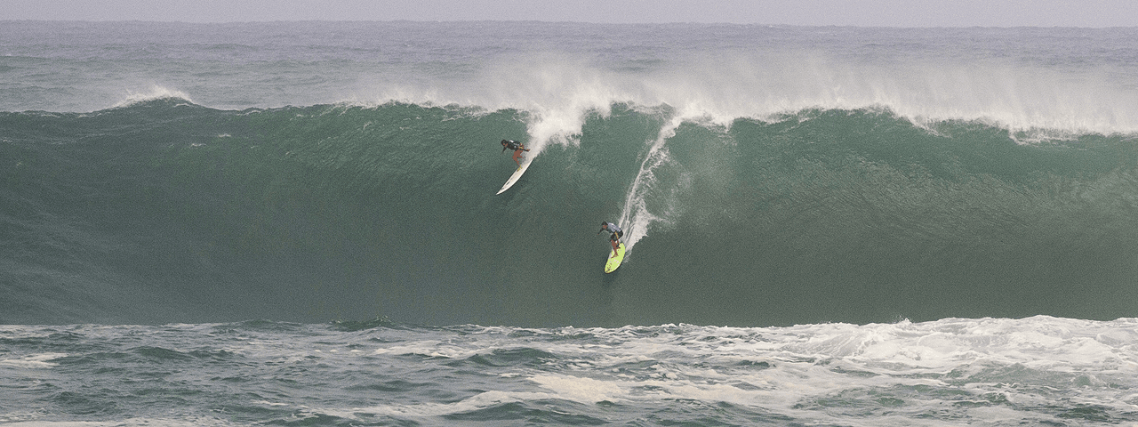 Jamie Mitchell, right, and Ross Clarke-Jones, both of Australia, surf in the Eddie Aikau big-wave surfing contest in Waimea Bay near Haliewa, Hawaii on Thursday, February 25, 2016. (AP Photo/Caleb Jones)