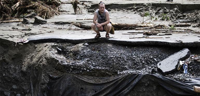 An overwhelmed resident surveys the damage following flooding caused by the remnants of Hurricane Beryl, July 11, 2024, in Plainfield, Vt. (AP Photo/Dmitry Belyakov, file)