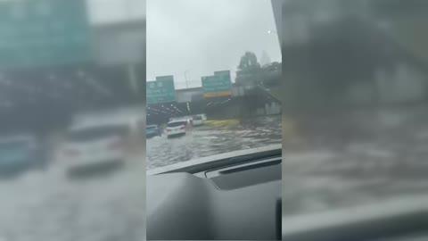 Motorists Drive Through Flooded Underpass