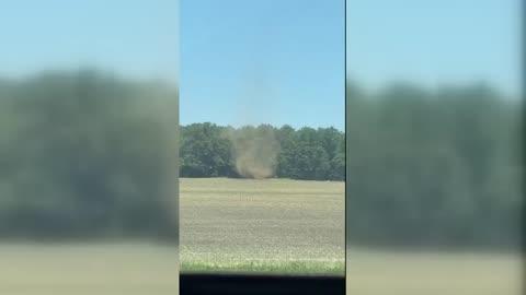 Dust Devil Spins Along Arid Field