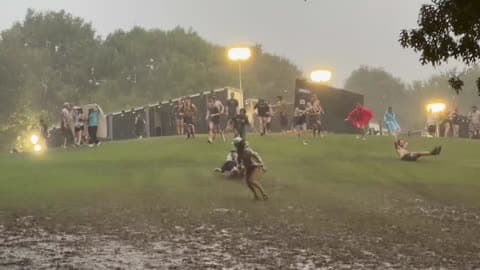 Atlanta Music Festival Attendees Slide Through Muddy Grass During Severe Weather